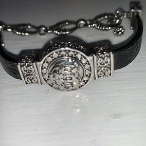One black embossed leather toggle snap bracelet with one snap.  NWT